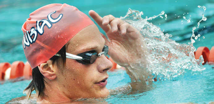 French triple Olympic medallist, swimmer Yannick Agnel adjusts his cap during a trainning session in the Meadowbrook Aquatic and Fitness Center on Thu