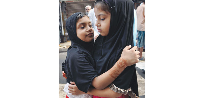 Children greet each other after Eid-al-Adha prayers in Kolkata yesterday.