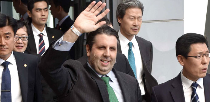US ambassador to South Korea Mark Lippert (centre) waves as he leaves Severance hospital in Seoul yesterday, following treatment for a knife attack.