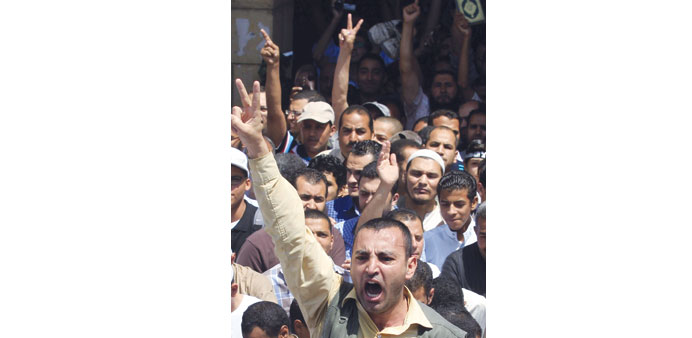 Protesters shout slogans during the rally in Cairo yesterday.