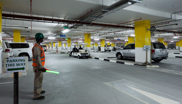  A staff assists motorists at the new parking lot