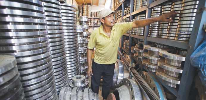 A worker looks at steel pipe fittings in a wholesale shop in Mumbai, India (file). Indiau2019s industrial output expanded for the first time in three mont