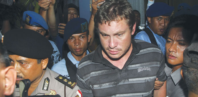    Indonesian police arrest Matt Christopher, a passenger of Virgin Australia airplane, at Denpasar airport in the resort island of Bali yesterday.