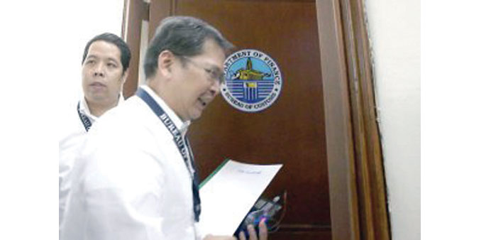 Customs Commissioner John Phillip Sevilla walks out after a news conference where he announced his resignation.