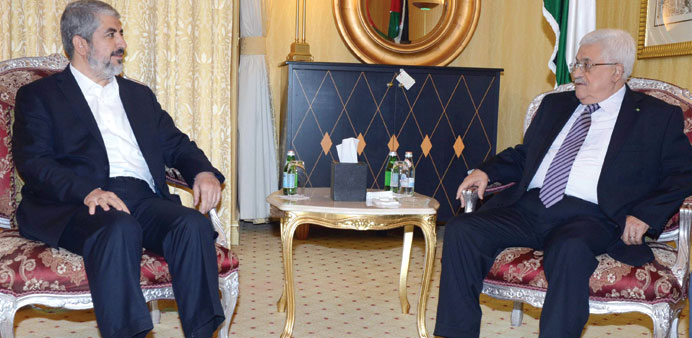 Palestinian President Mahmoud Abbas holding  talks with Hamas leader Khalid Mishal, in Doha yesterday.