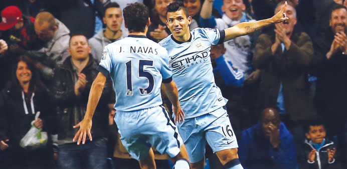 Manchester Cityu2019s Argentinean striker Sergio Aguero (right) celebrates with teammate Jesus Navas after scoring against Liverpool during Mondayu2019s Premi