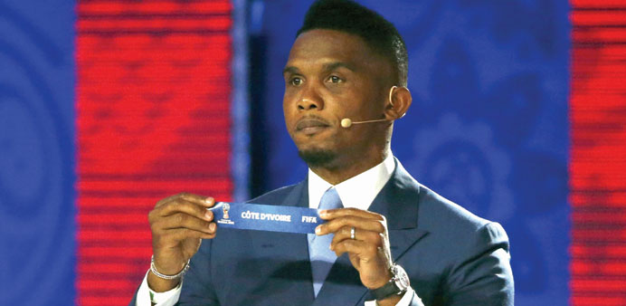 Cameroon player Samuel Etou2019o holds up the slip showing u201dCote Du2019Ivoireu201d during the draw in St. Petersburg yesterday.