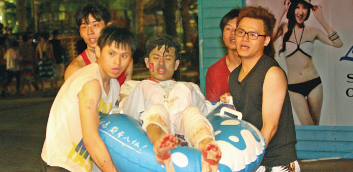 People carry an injured man at the Formosa Fun Coast amusement park after the explosion.