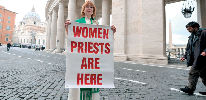 Excommunicated female priest Janice Sevre-Duszynska, holds a banner to draw attention to the lack of a voice for women, as cardinals gather at the Vat