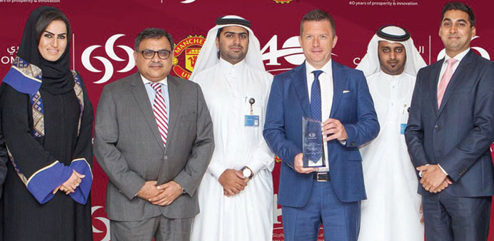 Commercial Bank officials with the innovation award from MasterCard.