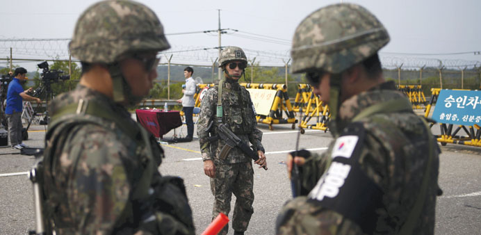 South Korean soldiers stand guard at a checkpoint on the Grand Unification Bridge, which leads to the truce village Panmunjom, just south of the demil