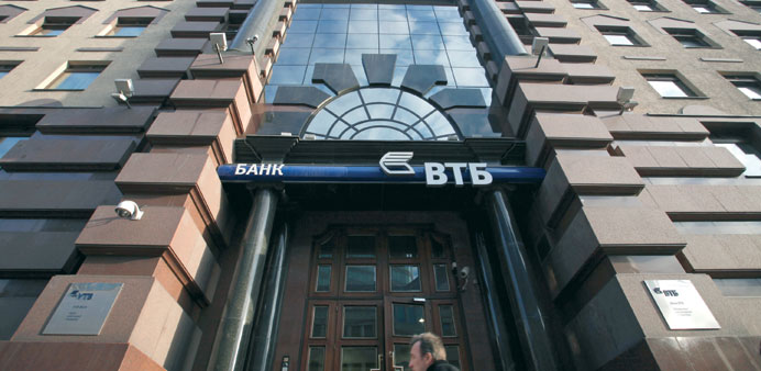 A pedestrian passes the headquarters of VTB Group in Moscow (file). Russiau2019s second-biggest lender has been working on a capital increase to support d