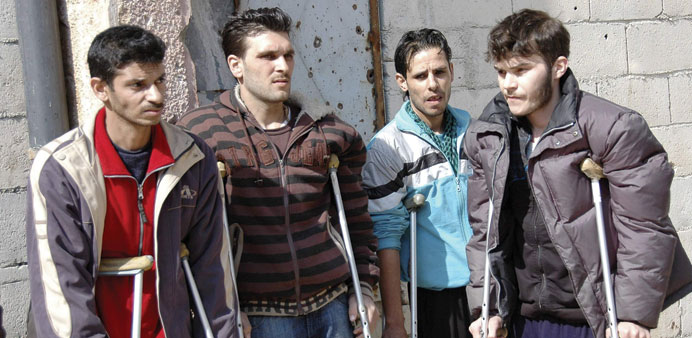 Civilians from besieged areas of Homs are seen in a shelter at an area under government control yesterday.
