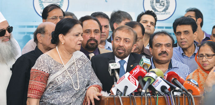 Muttahida Qaumi Movement (MQM) political party leader Farooq Sattar (c) speaks after party lawmakers submitted their resignations.