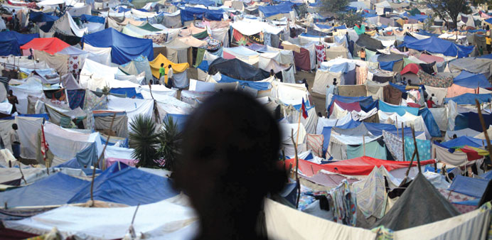 A January 26, 2010 file photo of a boy standing at a makeshift camp on the grounds of the Petionville Golf Course in Port-au-Prince.