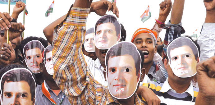 Supporters of Congress wear masks of party vice president Rahul Gandhi during an election campaign rally at Biswanath Chariali, some 20 kms from Guwah