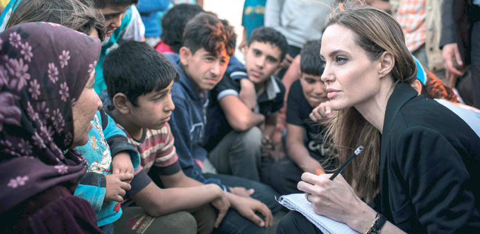  Angelina Jolie listens to Syrian refugees in a Jordanian military camp on Tuesday.