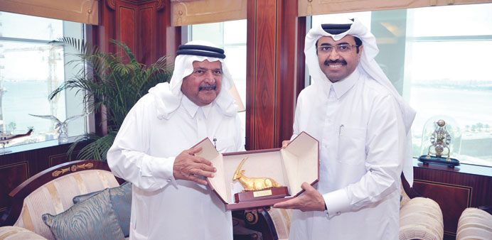 HE the Minister of Energy and Industry Dr Mohamed bin Saleh al-Sada receives his honorary membership to the Qatari Businessmen Association from QBA ch