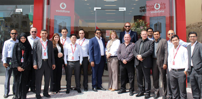 Vodafone officials and employees in front of the new Al-Aziziya Store.
