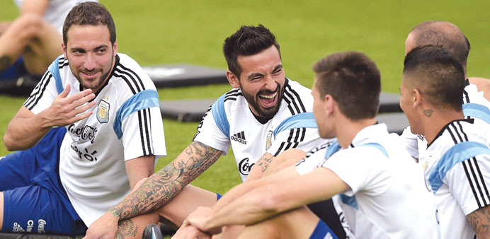 Argentinau2019s forwards Gonzalo Higuain (left) and Ezequiel Lavezzi laugh during a training session. (AFP)