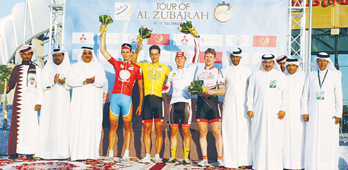Winners of the opening day's race of the inaugural Tour of Al Zubarah cycling event pose on the podium with Qatar Cycling Federation officials yesterd