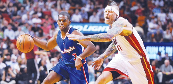 Los Angeles Clippers point guard Chris Paul is pressured by Miami Heat power forward Chris Andersen during the first quarter at American Airlines Aren