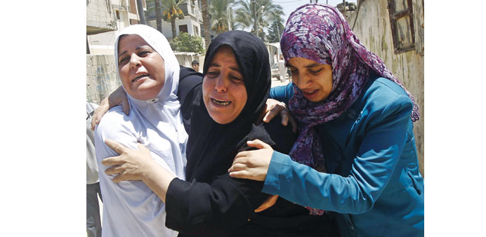 Palestinian relatives mourning during the funeral of a five-year-old girl killed in an Israeli air strike in Rafah  in the southern Gaza Strip yesterd