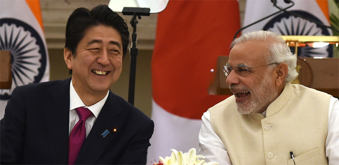 India's Prime Minister Narendra Modi (R) shares a light moment with Japan's Prime Minister Shinzo Abe (L) 