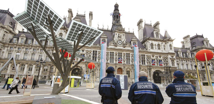 Security employees stand guard at the exhibition u201cParis de Lu2019Aveniru201d, a showcase for tangible climate solutions in the context of the COP21 World Clim