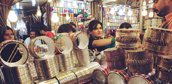 A Pakistani woman buys bangles ahead of the Muslim festivities of Eid al-Fitr, in Karachi yesterday.
