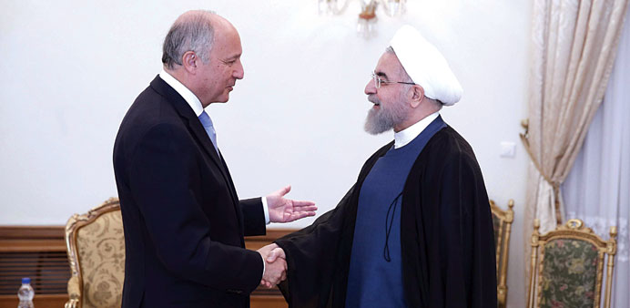 Rouhani welcomes Fabius in Tehran yesterday.