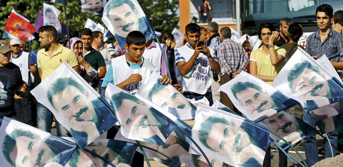 Demonstrators stand behind portraits of Kurdistan Workers Party (PKK)u2019s jailed leader Abdullah Ocalan during a march yesterday in solidarity with him 
