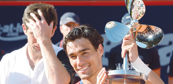 Italyu2019s Fabio Fognini holds the trophy after beating Argentinian Federico Delbonis (left) in Hamburg Open final yesterday. (Reuters)