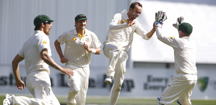 Australian off-spinner Nathan Lyon (second right) celebrates his 100th wicket with teammates during the third day of the fourth Ashes Test against Eng