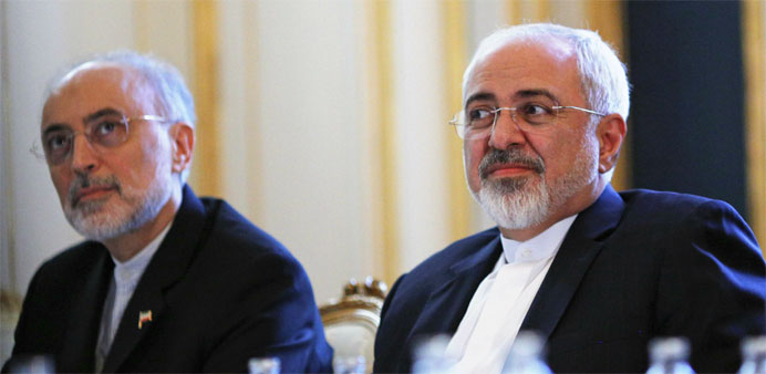 Iranian Foreign Minister Mohammad Javad Zarif (C) and the Head of the Iranian Atomic Energy Organization Ali Akbar Salehi (L) 