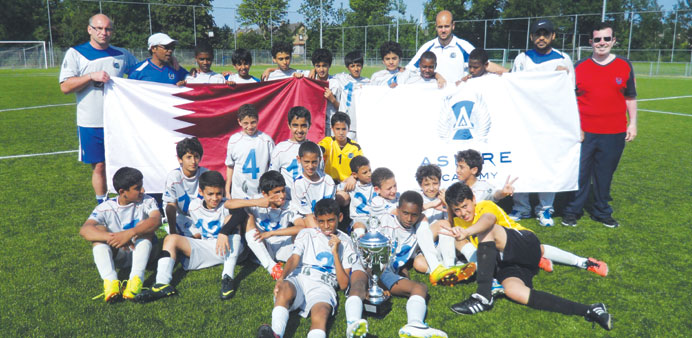 Aspire Academy players celebrate with the trophy.