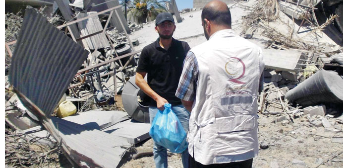 Qatar Charity aid distribution in progress amid the devastation in Gaza.