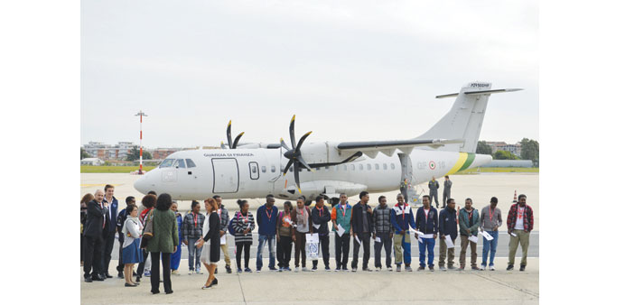  A group of Eritrean refugees prepare to board a plane to travel to Sweden as part of a new programme of the European Union to relocate refugees, at t