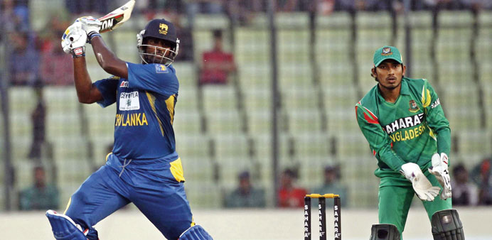 Sri Lankau2019s Thisara Perera cuts en route to his unbeaten 80 against Bangladesh in the first one-day international in Dhaka, yesterday. (Reuters)