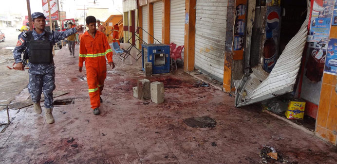 A policeman inspects yesterday the site of Fridayu2019s suicide bomb attack in Kirkuk.
