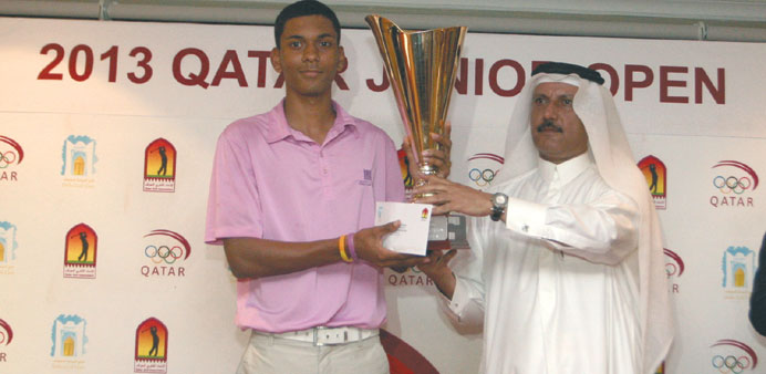  Yoseph Dance collects his trophy from Mohamed Ibrahim al-Mohannadi.