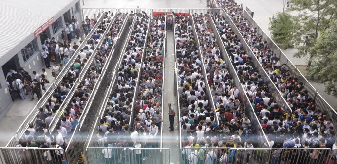 Passengers line up for a security check during morning rush hour at Tiantongyuan North Station in Beijing, which has tightened security checks at subw