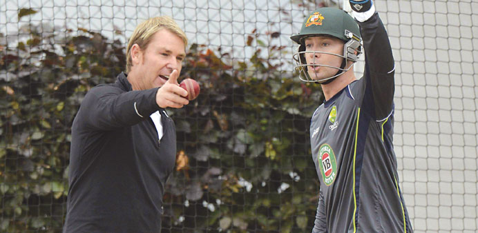 Australiau2019s captain Michael Clarke talks to former player Shane Warne (L) during a training session yesterday. (Reuters)
