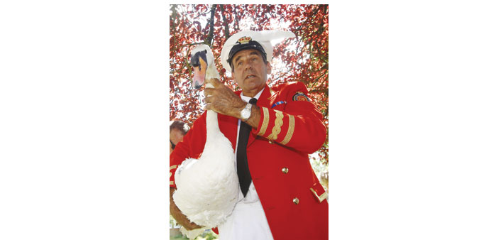 The Queenu2019s Swan Marker David Barber carries a swan back to the river during the annual Swan Upping ceremony on the River Thames between Shepperton an