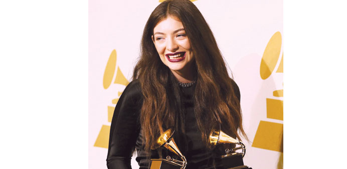 Pop singer Lorde poses backstage with her awards for song of the year and best pop solo performance for Royals at the 56th annual Grammy Awards in Los