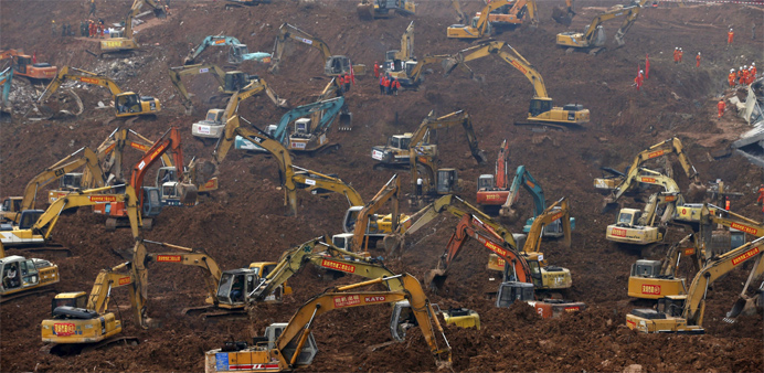 Excavators are seen during rescue operations at an industrial estate hit by a landslide in Shenzhen, Guangdong province