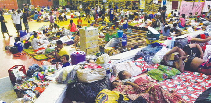 Filipino residents sleep on the floor as they seek refuge inside a gymnasium turned into an evacuation centre in Sorsogon City, Bicol region, Philippi