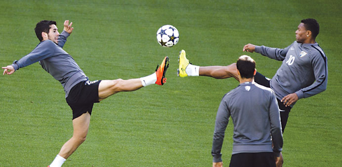 Francisco R Alarcon u2018Iscou2019 (left) fights for the ball with teammate Julio Baptista during a training session yesterday. (EPA)