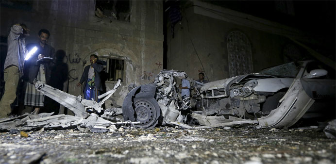 Police officers inspect the site of a car bomb attack in Yemen's capital Sanaa 