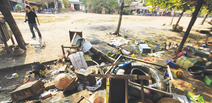 Destroyed furniture and belongings are seen in a market in Sit Kwin yesterday.